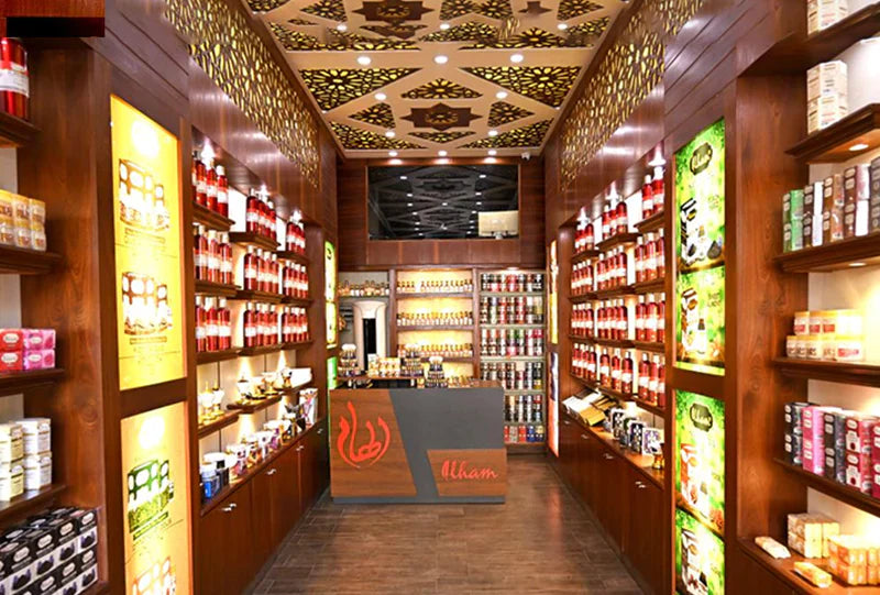 Ilham Perfumes bottle surrounded by soft mist and golden tones